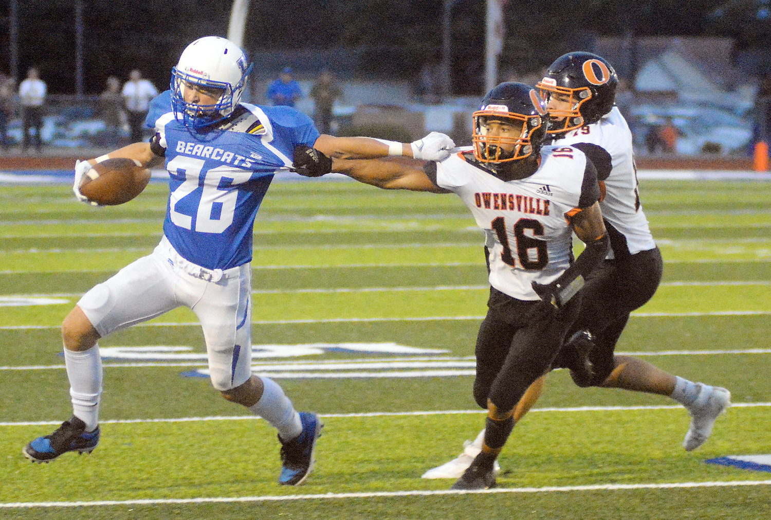 Dezmyn Moore (above, second from left) reaches out to grab Kole Eldringhoff’s jersey in hopes of slowing him up during the annual Gasconade County Bowl football game Friday night between the host Hermann Bearcats and Owensville Dutchmen.  OHS will host Pacific Friday night at 7 p.m., to celebrate their annual homecoming.